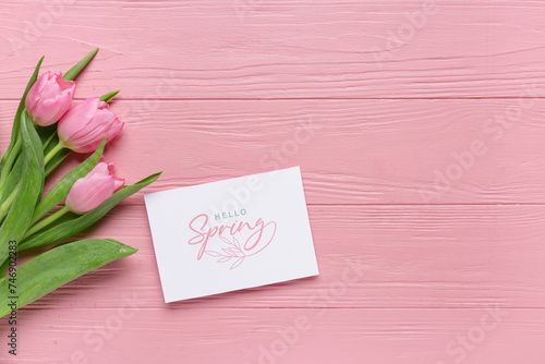 Fototapeta Naklejka Na Ścianę i Meble -  Greeting card with text HELLO SPRING and beautiful tulips on pink wooden background