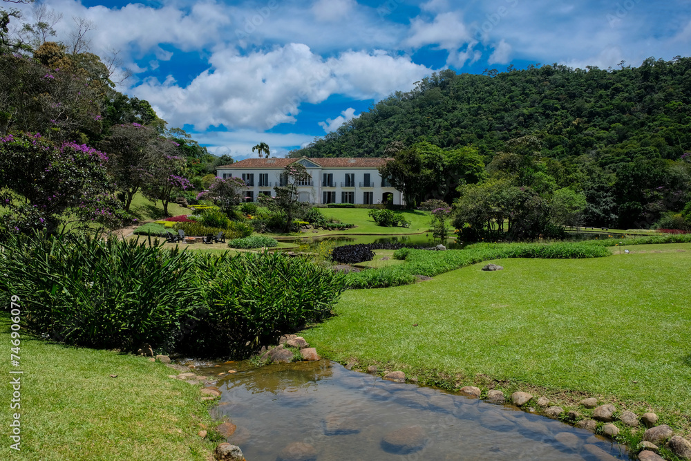 Fazenda Marambaia, Rio da Janeiro, Brazil, Elegant colonial-style manor surrounded by a lush Burle Marx-designed garden, featuring vibrant flowers and a tranquil pond