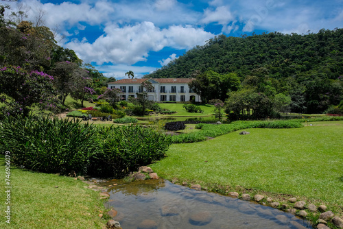 Fazenda Marambaia  Rio da Janeiro  Brazil  Elegant colonial-style manor surrounded by a lush Burle Marx-designed garden  featuring vibrant flowers and a tranquil pond