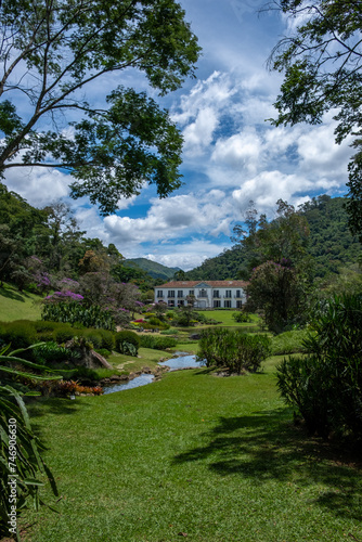 Fazenda Marambaia  Rio da Janeiro  Brazil  Elegant colonial-style manor surrounded by a lush Burle Marx-designed garden  featuring vibrant flowers and a tranquil pond