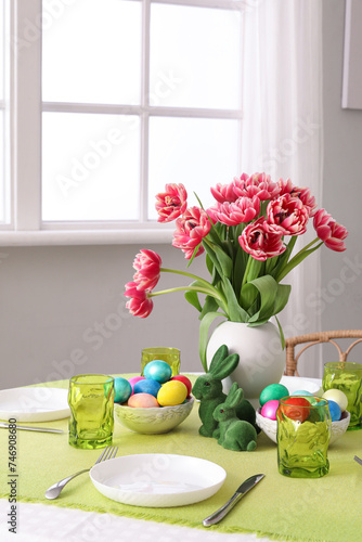 Beautiful table serving with red tulips for Easter celebration