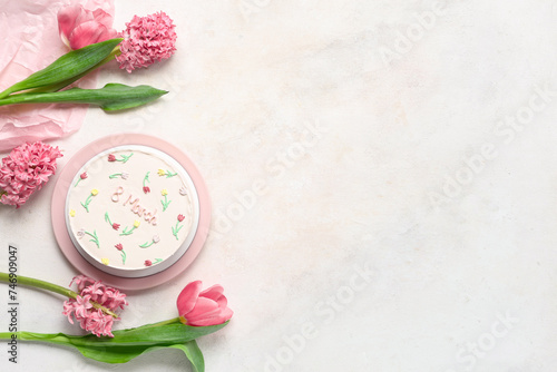Sweet bento cake and beautiful flowers on white background. International Women's Day
