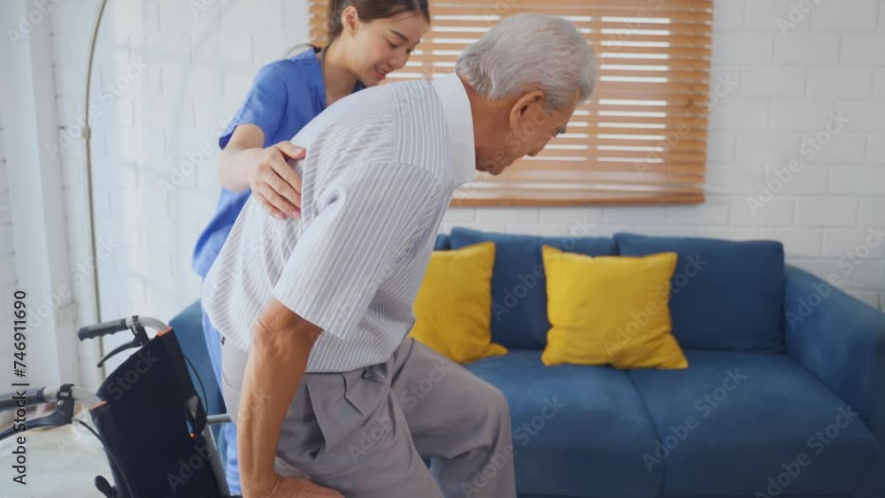 Asian young caregiver take care senior man on wheelchair in house. Asian young caregiver take care senior man on wheelchair in house.