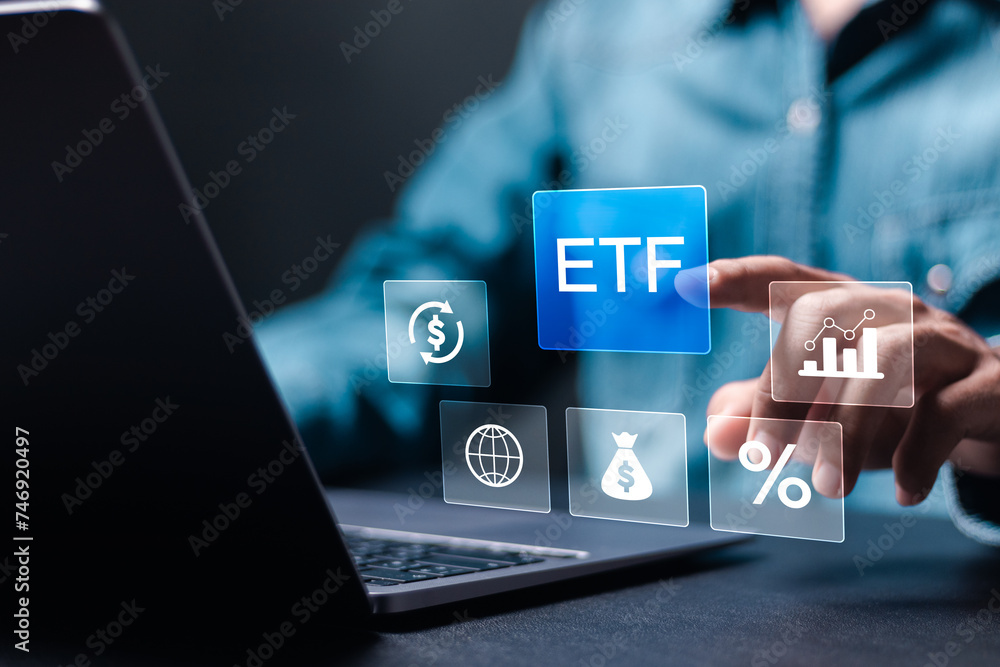 Fototapeta premium ETF, Exchange traded fund concept. Business stock market finance index fund. Businessman use laptop with ETF icons on virtual screen.