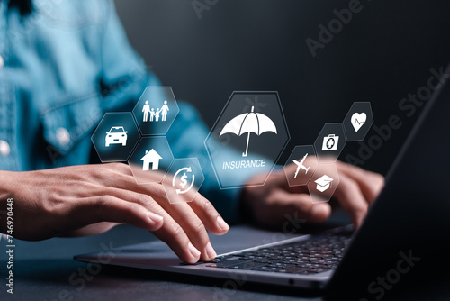 Online insurance concept. Person use laptop with online insurance icon on virtual screen for car, family and life, financial and health insurance.