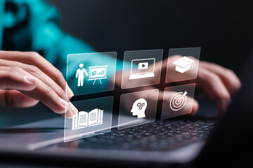 E-learning education concept. Learning online with webinar, video tutorial, internet lessons. Businessman use laptop with E-learning icon on virtual screen.