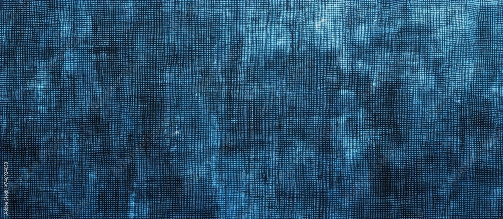 A seamless blue textured background featuring small squares in varying shades, resembling the natural hues of autumn and winter. The squares create a visually appealing geometric pattern on a rough A seamless blue textured background featuring small squares in varying shades, resembling the natural hues of autumn and winter. The squares create a visually appealing geometric pattern on a rough