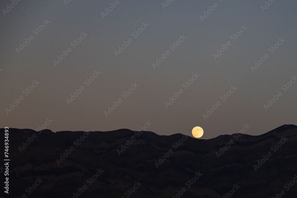 Fototapeta premium Full moon rising, mountain background