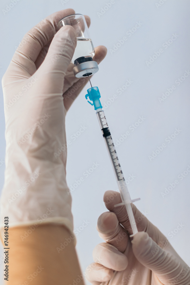 Hand holding syringe with vaccine. Close- up. Vaccination concept, health. Covid-19 Hand holding syringe with vaccine. Close- up. Vaccination concept, health. Covid-19