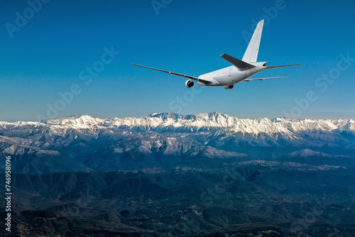 A white wide body jetliner approach in a resort mountain town