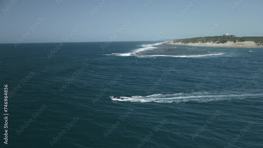 Aerial tracking shot of a small boat sailing off the coast of mozambique Aerial tracking shot of a small boat sailing off the coast of mozambique
