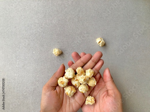 Handful of popcorn on gray plain background photo