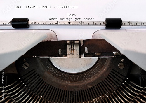 Typewriter with screenwriting scene written.  Concept of professional screenwriter doing his work,  TV  movie or film script writing -  story telling in a screenplay photo
