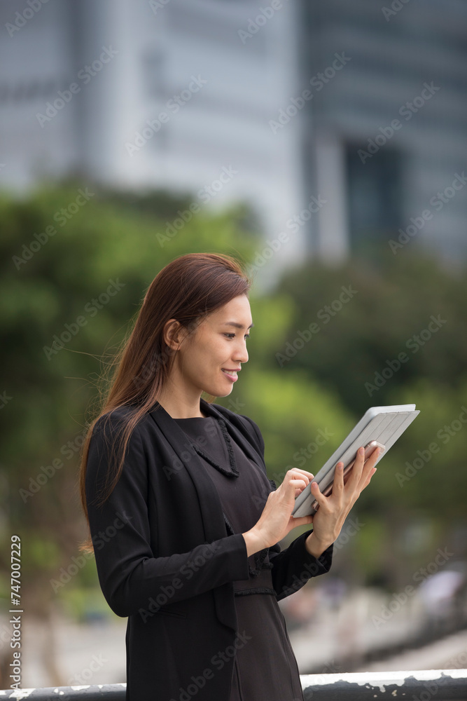 Asian business woman using a digital tablet. Asian business woman using a digital tablet.