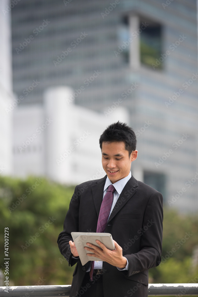 Asian business man using tablet computer. Asian business man using tablet computer.