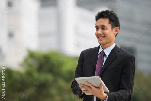 Asian business man using tablet computer.