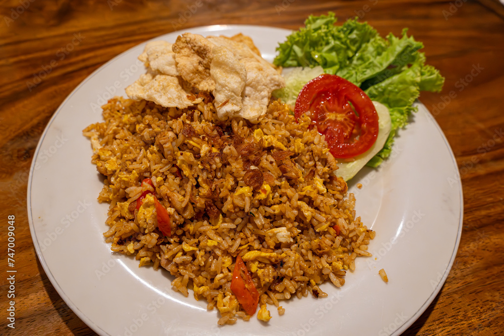 One serving of a mouth watering fried rice with condiments One serving of a mouth watering fried rice with condiments