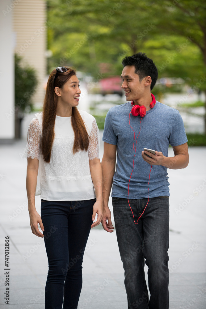 Happy Chinese couple walking together.