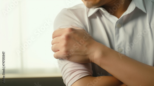 Person Clutching Their Sore Elbow in Pain