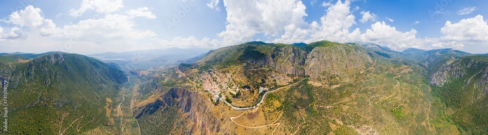 Delphi, Greece. Ruins of the ancient city of Delphi and the modern city. View of the valley. Sunny weather, Summer. Panorama 360. Aerial view