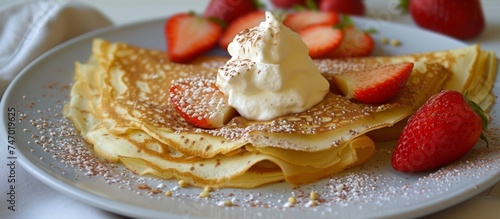 Delicious homemade pancakes topped with fresh strawberries and fluffy whipped cream