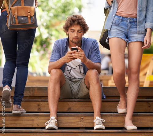 Fototapeta Naklejka Na Ścianę i Meble -  Phone, school and student man on stairs of university or college campus for social media break. Education, scholarship and study with young person typing mobile text message on steps at recess