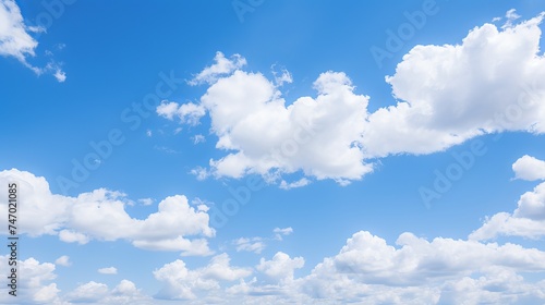 White fluffy clouds in a clear blue sky on a sunny day