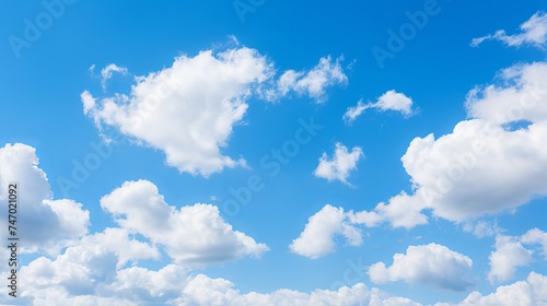 White fluffy clouds in a clear blue sky on a sunny day
