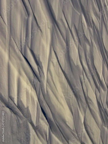 Abstract pattern of waves on a snowy field. Arctic, Russia.