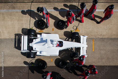 Pit crew in perfect harmony during a highprecision Formula 1 pit stop.