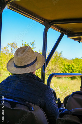 Unreconizable man in hat while in a Safari Adventure in Africa photo