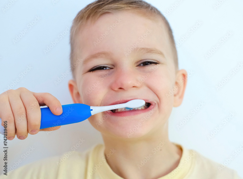 Happy child boy brushes his teeth. Healthcare, oral hygiene, people and beauty concept Happy child boy brushes his teeth. Healthcare, oral hygiene, people and beauty concept