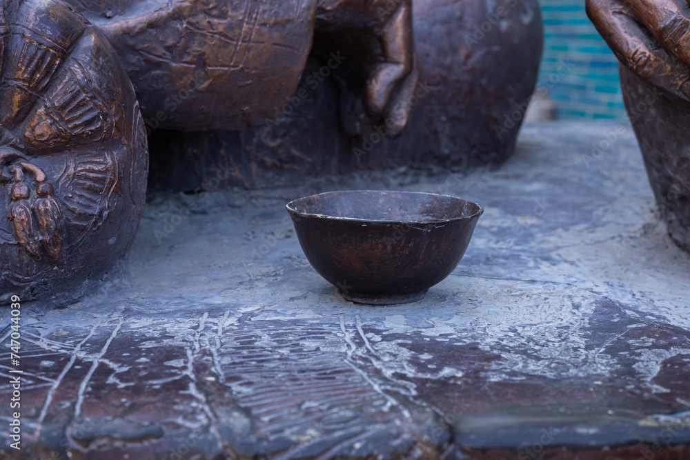 Bronze sculpture of bowl close up in Ichan qalʼa, Khiva, Uzbekistan Bronze sculpture of bowl close up in Ichan qalʼa, Khiva, Uzbekistan