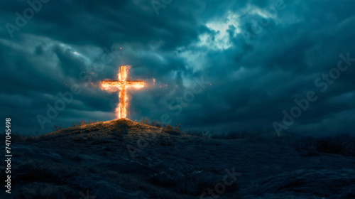 Burning wooden cross on mountain or hill top or peak, dark clouds on the sky. Christian faith or religion, crucifixion of Jesus Christ, Calvary sacrifice for salvation and forgiveness