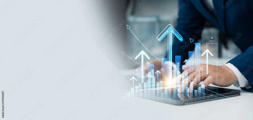 Businessman use laptop and tablet analyzing company growth, future business growth arrow graph, development to achieve goals, business outlook, financial data for long term investment. - obrazy, fototapety, plakaty 