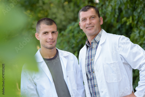 portrait of scientists checking plants outdoors