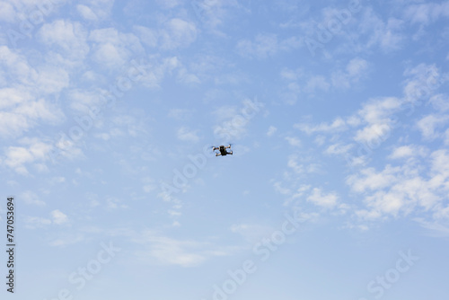 Drone against the blue sky, photo from the ground