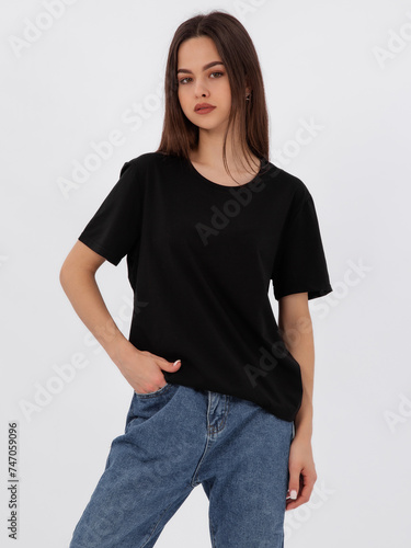 mockup of a black loose-fitting t-shirt on a young beautiful girl