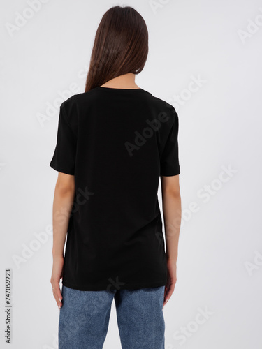 mockup of a black loose-fitting t-shirt on a young beautiful girl