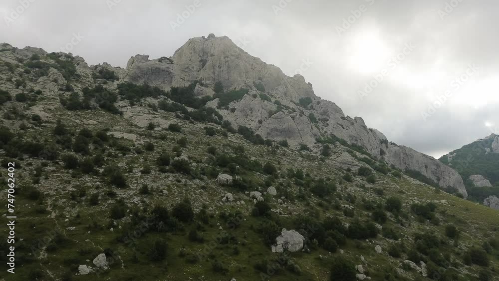 Aerial flight: Flying closer to the mountains of Croatia's Velebit National Park on a cloudy morning. Aerial flight: Flying closer to the mountains of Croatia's Velebit National Park on a cloudy morning.