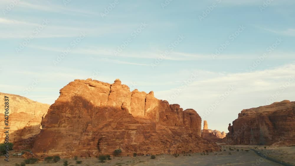 Orange rocks and desert with yellow sand at sunset. Al Ula, Saudi Arabia - Aerial drone view. Orange rocks and desert with yellow sand at sunset. Al Ula, Saudi Arabia - Aerial drone view.