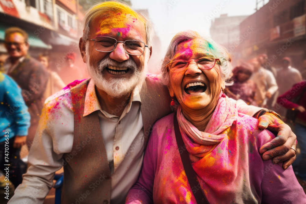 Joyous senior couple celebrating Holi with colorful smiles