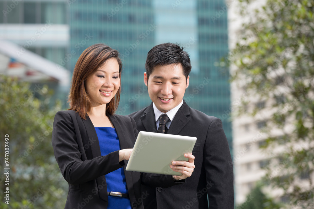 Asian Business people outside with tablet Asian Business people outside with tablet