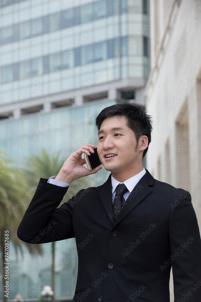 Chinese business man using a smartphone.