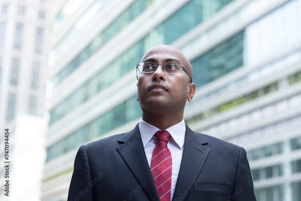 Confident Indian Business man standing in modern city