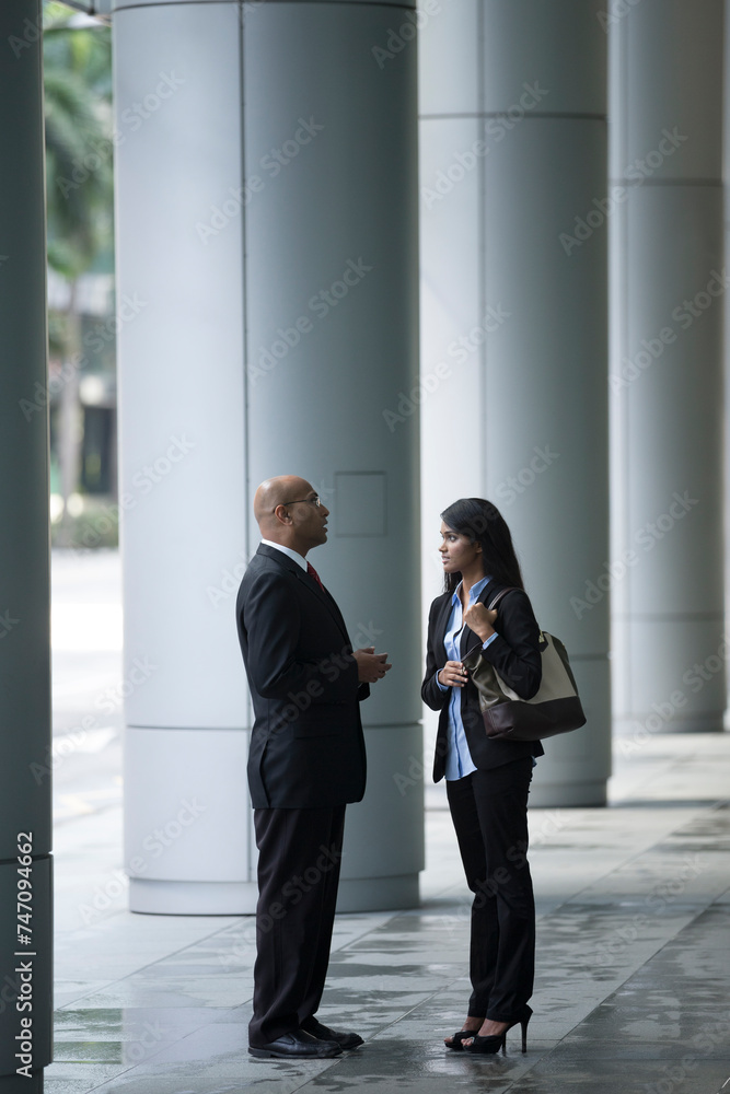 Happy Indian Business colleagues talking to each other. Happy Indian Business colleagues talking to each other.