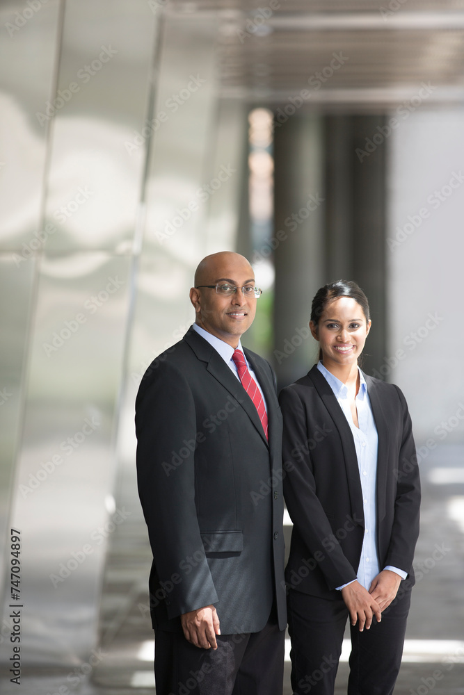 Indian business man and woman in a modern urban setting.