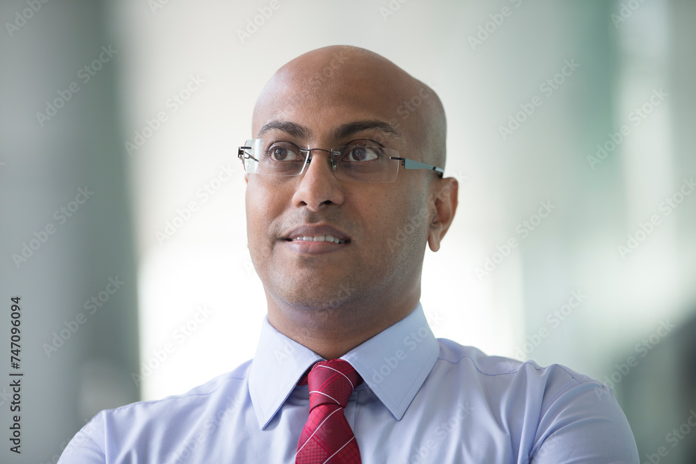 Confident Indian Business man standing in modern city Confident Indian Business man standing in modern city