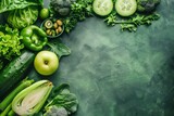 Fresh green organic vegetables and fruits on green background. Healthy food, diet and detox concept. Flat lay, top view