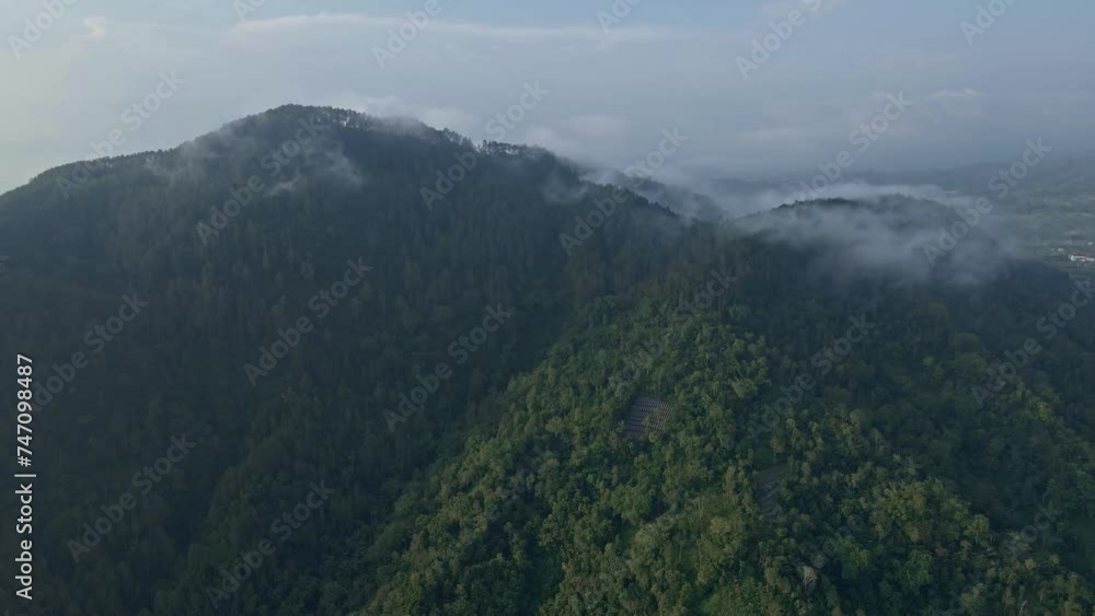 Drone camera of forest and hill. view of fog that covers mountain peaks covered by dense rainforest. 4K aerial drone shot.